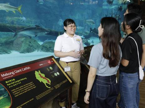 a volunteer speaking to visitors